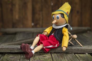 Old wooden pinocchio marionette toy . - obrazy, fototapety, plakaty