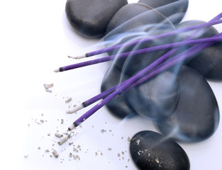 Incense and stones on a white background