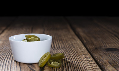 Jalapenos on wooden background