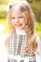 Laughing kid girl 3-4 year old outdoors. Smiling cute child. Childhood. 