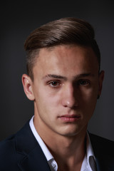 young businessman isolated on gry