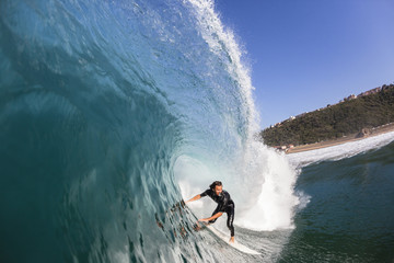 Surfing Surfer rides Inside Large Blue Hollow crashing ocean wave swimming photo action