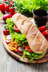 Vegan sandwich with salad, tomato and radish