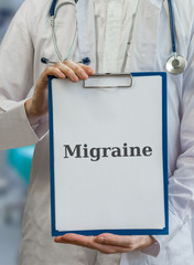 Doctor holds clipboard with migraine diagnosis