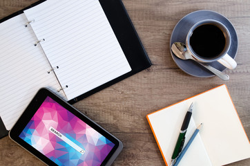 Digital tablet computer with sticky note paper and cup of coffee