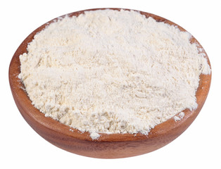 White flour in a wooden bowl on a white