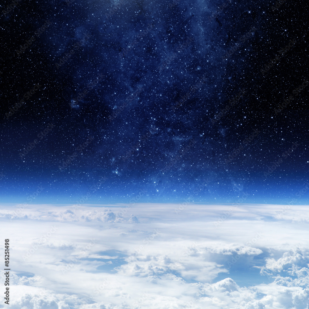 Wall mural clouds of earth planet and star sky on the background. elements of this image are by nasa