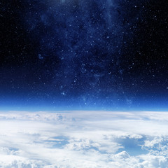 Clouds of Earth planet and star sky on the background. Elements of this image are by nasa