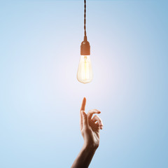 hand points to  light bulb