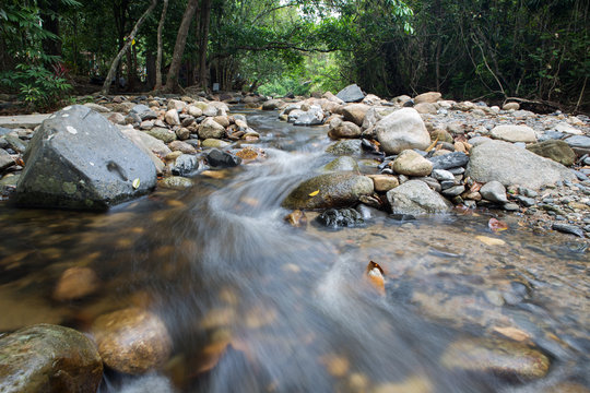 running of water stream from waterfall in tropical rain forest