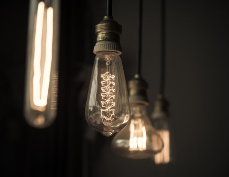 Hanged light bulbs in dark room vintage