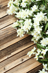 White flowers of jasmine on brown wooden background
