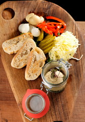 Rustic breakfast. sandwich with liver pate, spring vegetables - radishes, green onions, cucumbers and butter