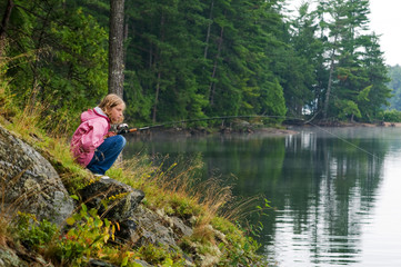 Fototapeta na wymiar girl fishing on a lake