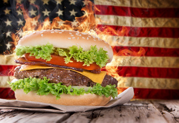 Fototapety  Pyszny hamburger z ognistymi płomieniami