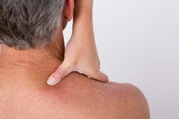 Doctor examining her patient shoulder