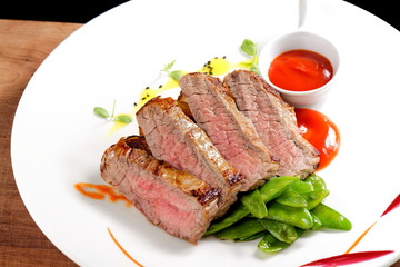 Roasted Kobe Marbled beef fillets with snow peas and tomato sauce