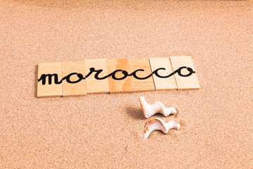 Words formed from small pieces of wood containing a sun and beach tourist destination, Morocco