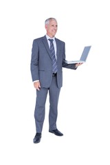 Happy businessman holding laptop computer 