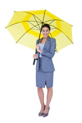 Smiling businesswoman sheltering under umbrella © WavebreakmediaMicro