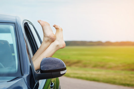 Woman's legs out of the car window