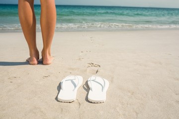 Fototapeta na wymiar Feet of woman at the beach