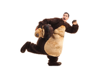Terrified man in a bear costume running away