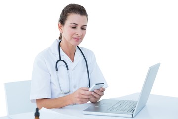  Doctor working on her laptop and her phone