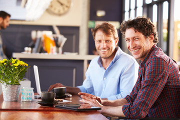 Two men meeting at a coffee shop, portrait