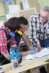 Young people in carpentry course with teacher