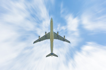 An airplane moving in the blue sky and white clouds