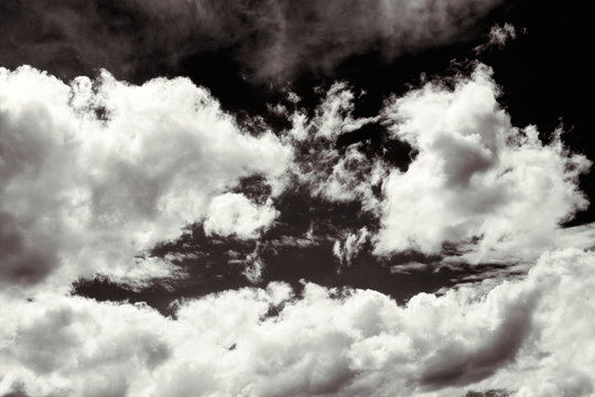 Cumulus clouds in black and white for dramatic effect. 