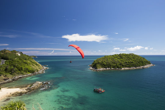 Sail of a paraglider in a blue sky over the sea