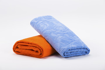 Blue and orange beach towels isolated on white