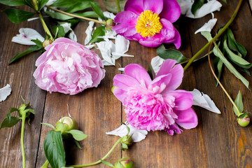 white and pink peonies bouquet from flowers market on a dark wood table in rustic style