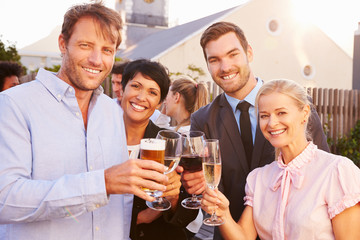 Colleagues drinking after work at a rooftop bar