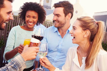 Group of friends drinking at a rooftop bar