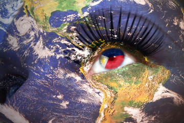 womans face with planet Earth texture and philippines flag inside the eye