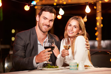 Couple eating dinner at rooftop restuarant