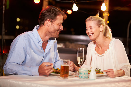 Couple Eating Dinner At Rooftop Restuarant