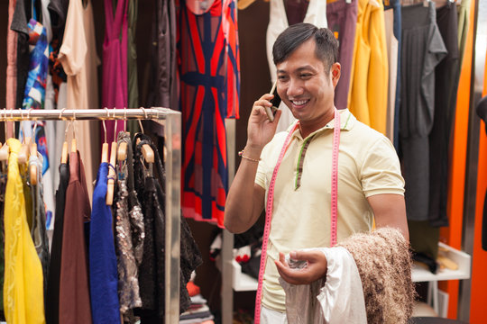 Asian man tailor phone call talking fashion clothes dress 