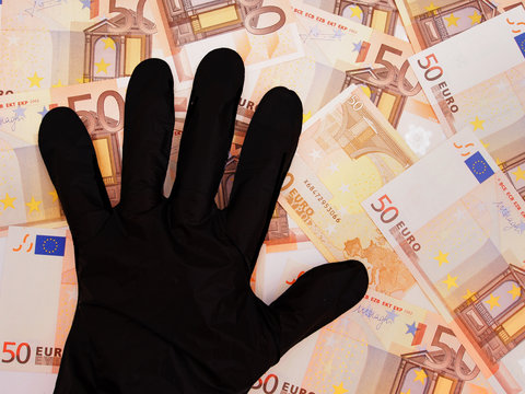 Black gloved hand stealing Euro currency, financial curruption c