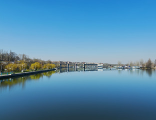 Fototapeta na wymiar deep blue sky over river with bridge