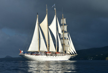 Fototapeta na wymiar Sailing ship on the background of a stormy sky
