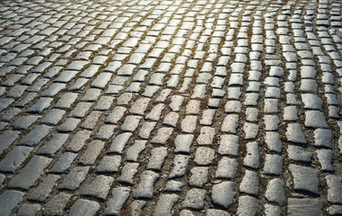 Fototapeta premium cobbled road as background on sunset