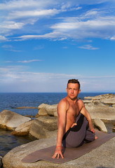  man is engaged in gymnastics, yoga in nature