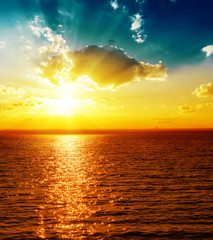 sunset over dark river