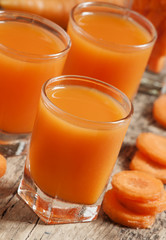 Fresh carrot juice in the glass, selective focus