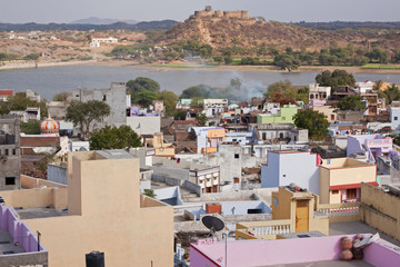 Typical Rajasthani urban housing with the ancient Deogarh fort and Raghosagar Lake in the background