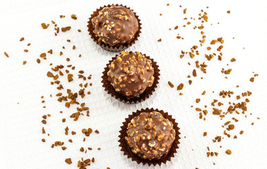 Top view of chocolate bonbons on white towel